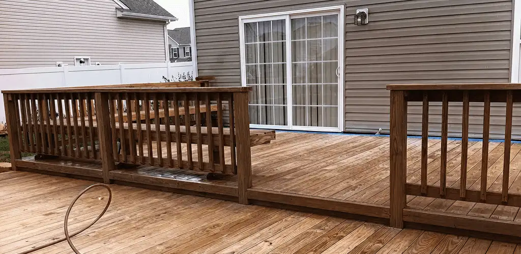 Deck sealing service protecting a backyard wood deck and railings in Bloomington, IN