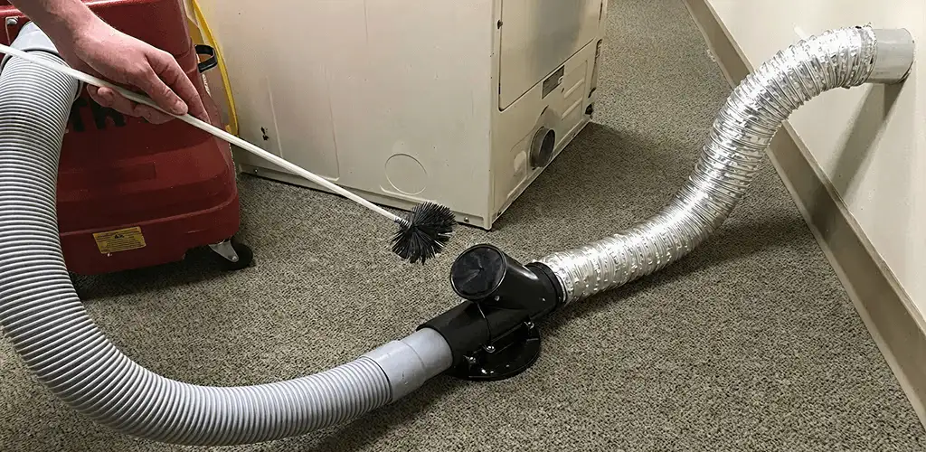 Dryer vent cleaning service removing lint from a dryer duct connection in Bloomington, IN
