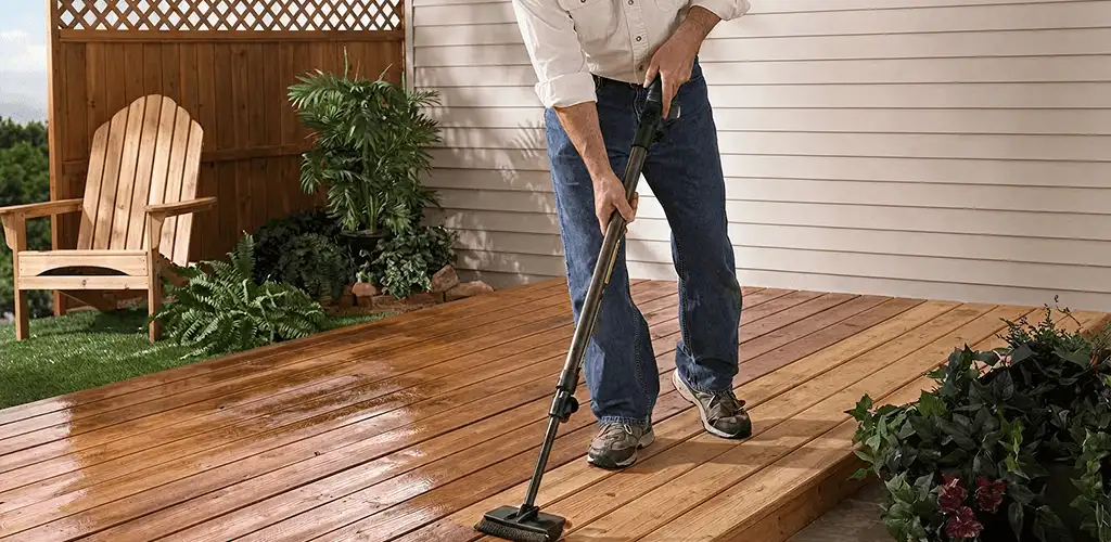 Deck staining service applying stain to a backyard wood deck in Bloomington, IN